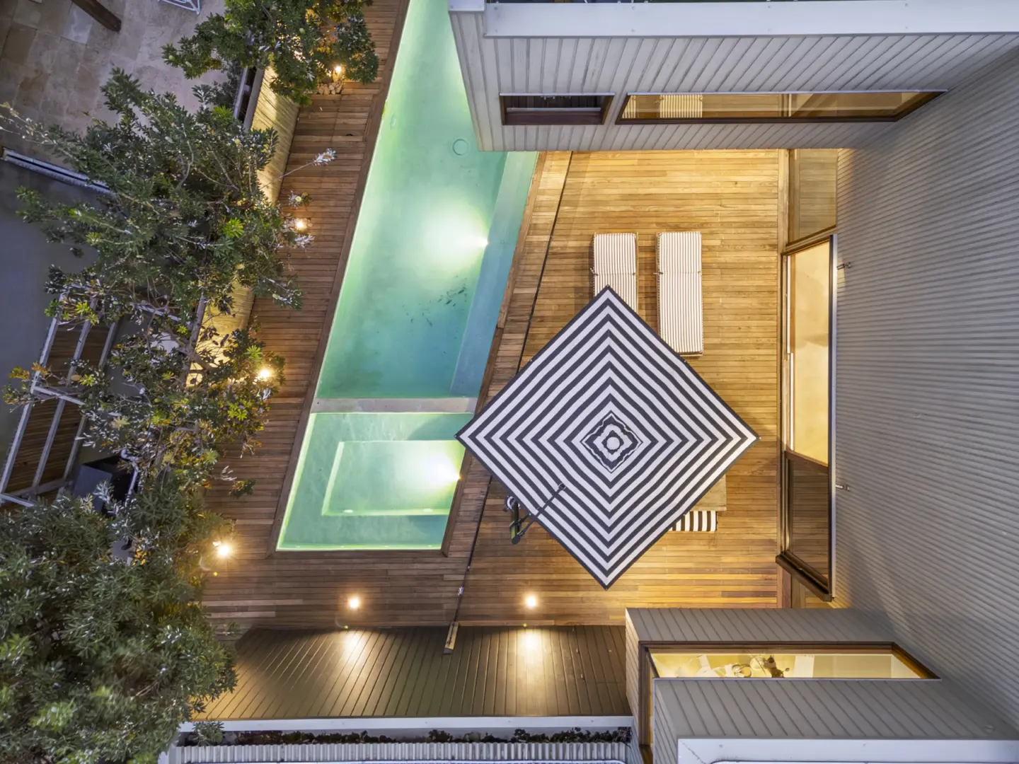 Aerial view of a beautifully presented coastal home and pool